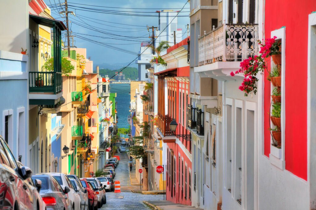 In the heart of San Juan, Puerto Rico, a picturesque street bursts with vibrant hues, traditional architecture, and lively culture, inviting exploration and celebration of its rich heritage.
