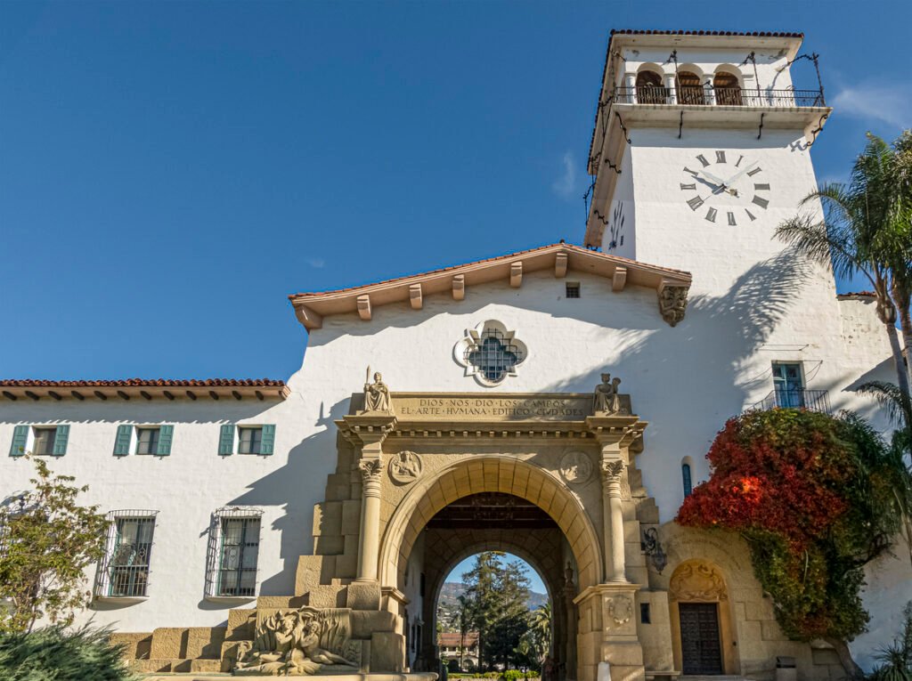On November 30, 2023, Santa Barbara, CA, USA, witnessed the majestic Santa Barbara County Courthouse, adorned with a monumental great arch crafted in white stone, standing tall against the backdrop of a serene blue sky.