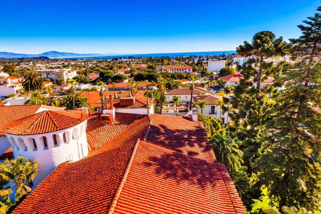 California, the iconic courthouse buildings boast vibrant orange roofs against the backdrop of the serene Pacific Ocean, creating a captivating coastal skyline in Santa Barbara.