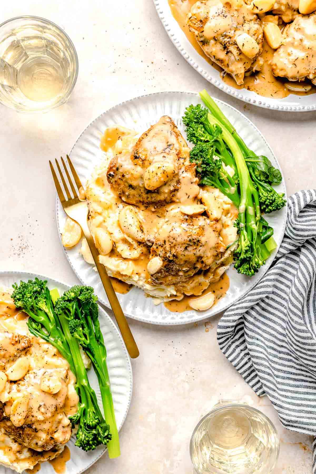 Overhead image of 40 clove garlic chicken served on a plates with broccolini.