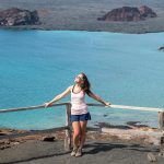 solo female traveler in South America posing in front of turquoise waters in the Galapagos