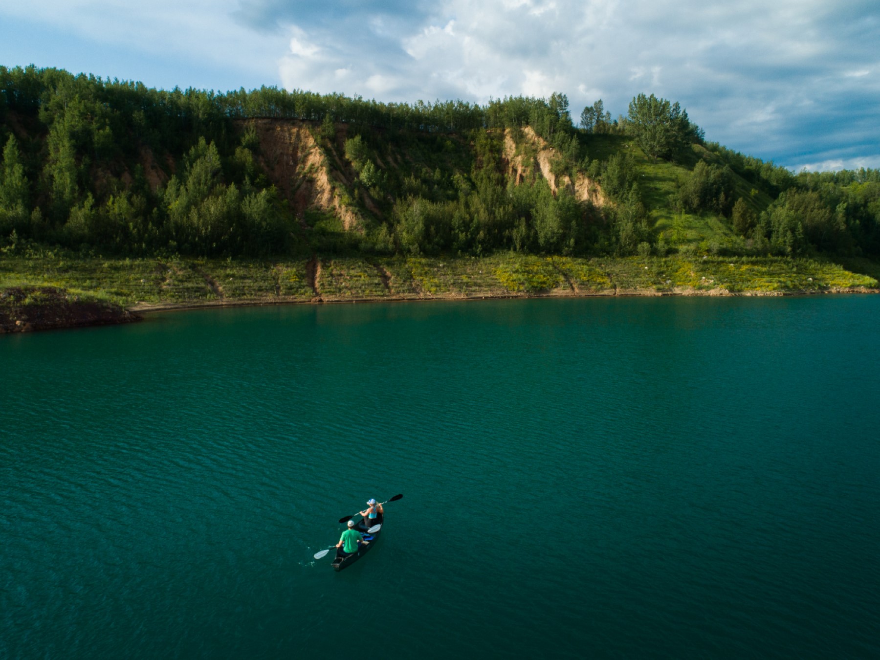 Two paddlers make their way across a mine pit lake in northern Minnesota.